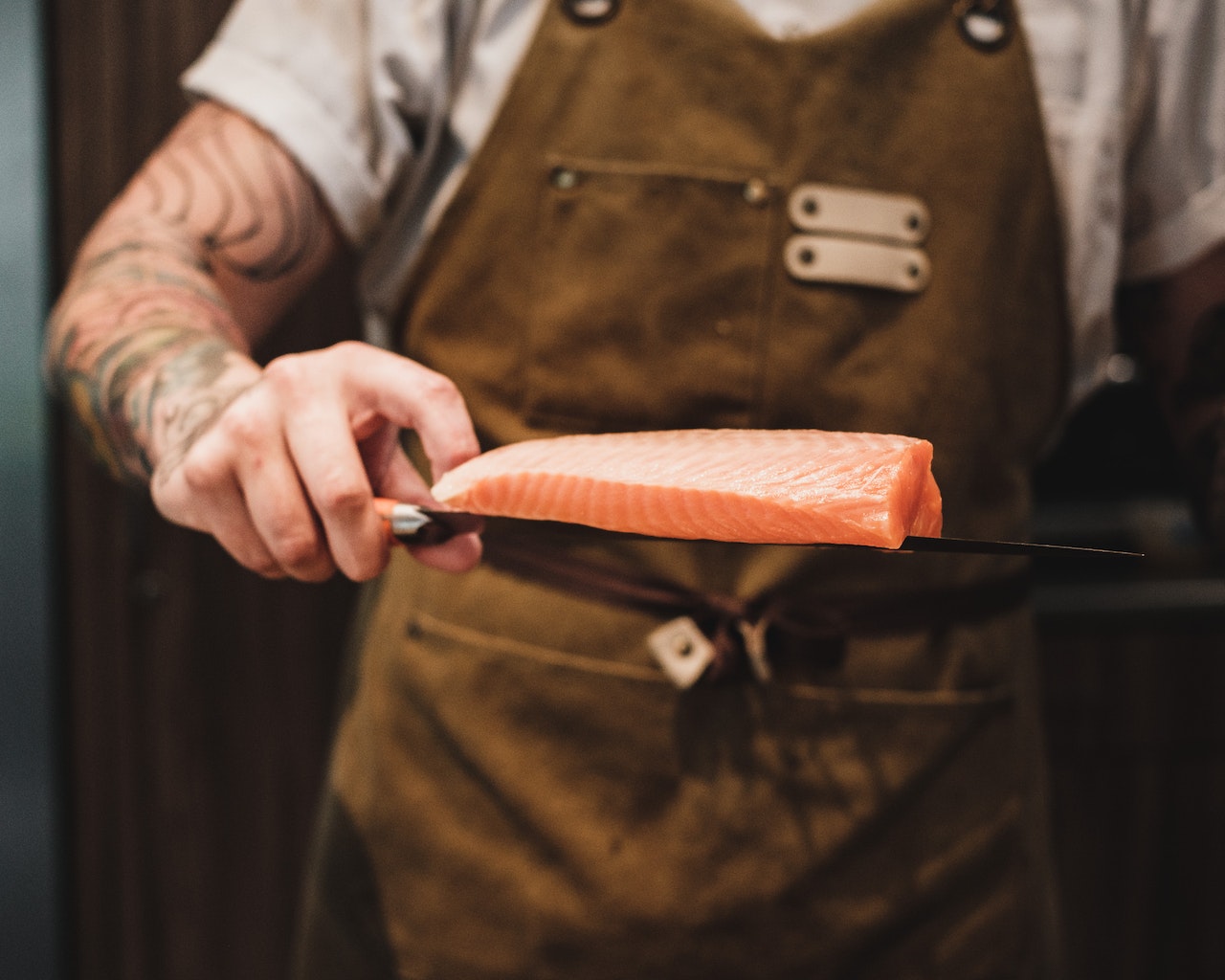 chef using a miyabi knife on salmon