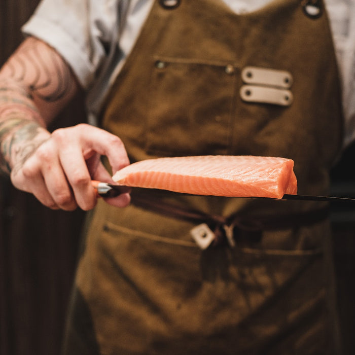 chef using a miyabi knife on salmon