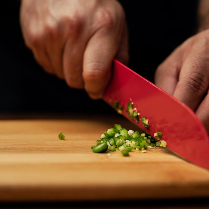 using knife to cut vegetables