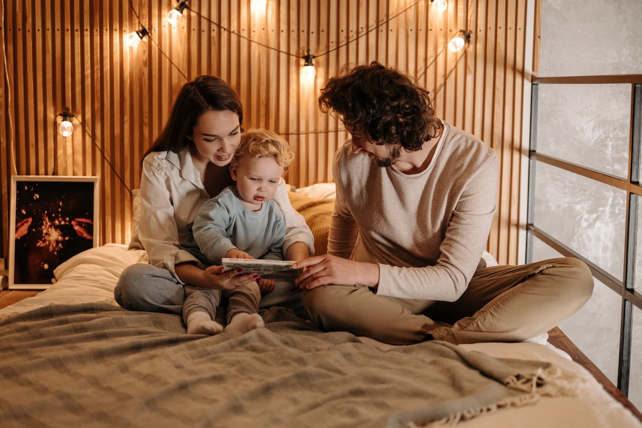 couple and child in boho-inspired bedroom