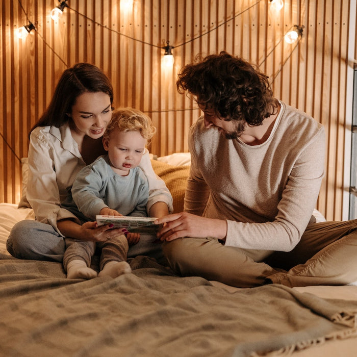 couple and child in boho-inspired bedroom